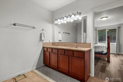 a bathroom with a sink a vanity and a mirror
