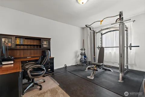 a view of a workspace with furniture and a window