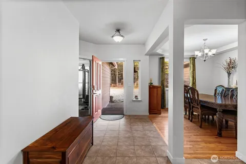 a view of a hallway with furniture and windows