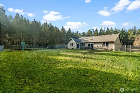 a patio with table and chairs and potted plants