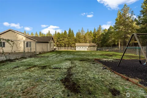 a aerial view of a house with swimming pool and green space