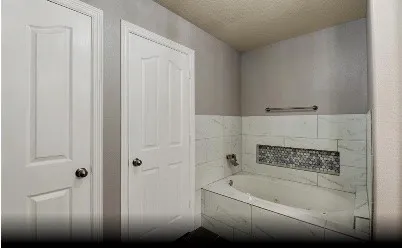 a bathroom with bathtub and shower