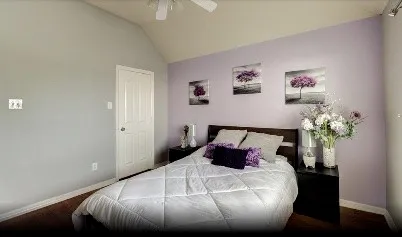 a bedroom with a bed and a potted plant