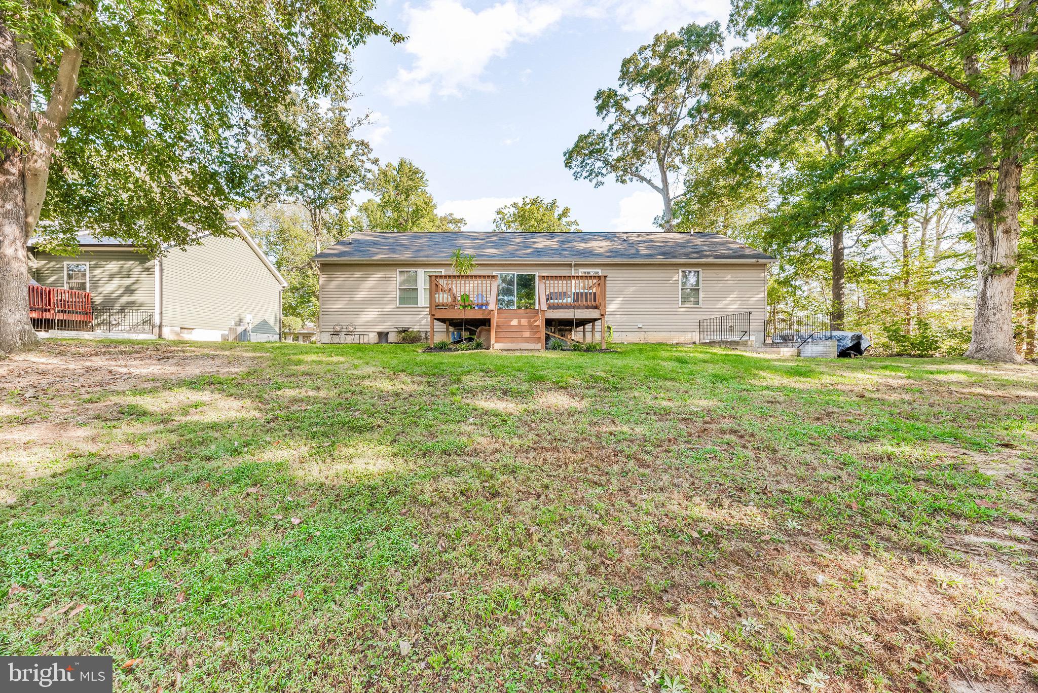 11156 Rawhide Road Lusby, MD 20657 - Photo 31 of 33 a view of a house with a big yard and large trees