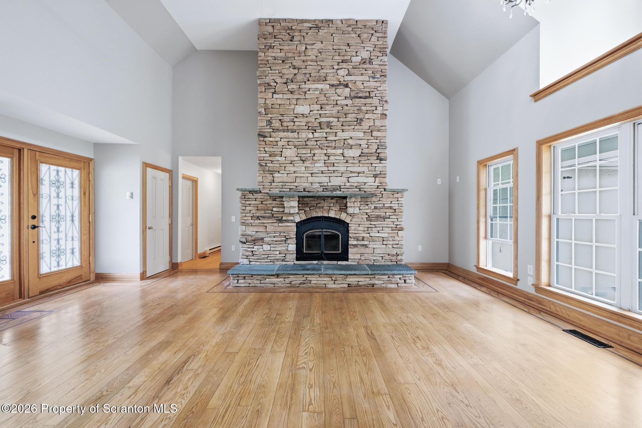 116 Forge Street Old Forge, PA 18518 - Photo 3 of 49 wooden floor fireplace and windows in an empty room