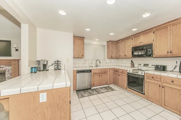 a kitchen with a sink stove and cabinets