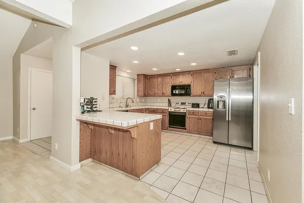 a kitchen with stainless steel appliances granite countertop a sink and cabinets