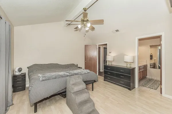 a spacious bathroom with a granite countertop double vanity and a mirror