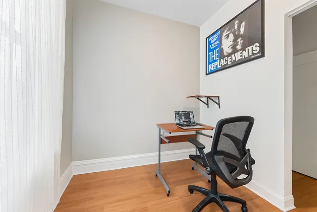 a view of a workspace with furniture and a window