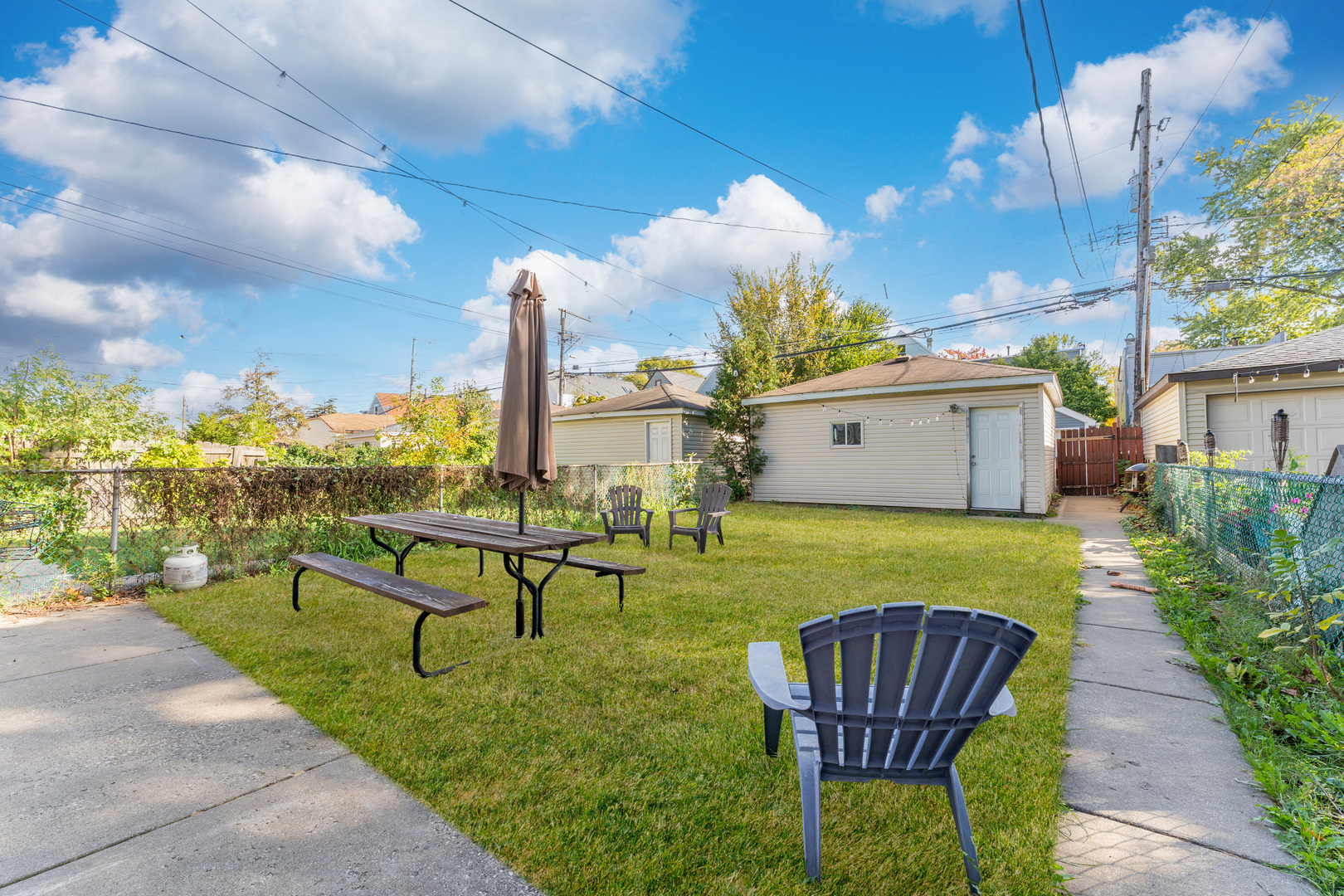 2703 North Ridgeway Avenue, Unit 2 Chicago, IL 60647 - Photo 9 of 9 a view of a chairs and table in the back yard of the house