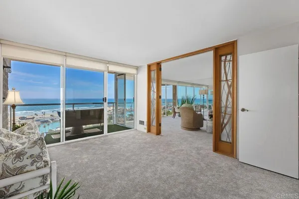 a spacious bedroom with a bed and a cabinets