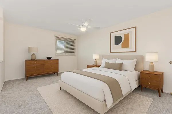 a view of an empty room with a ceiling fan