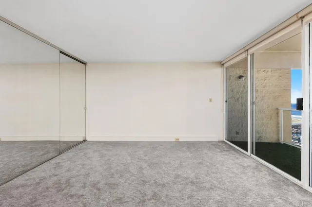 an empty room with yard and balcony