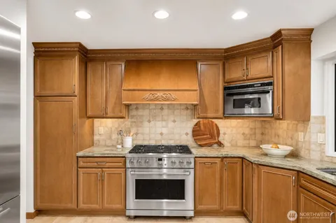 a kitchen with a stove a sink and a refrigerator