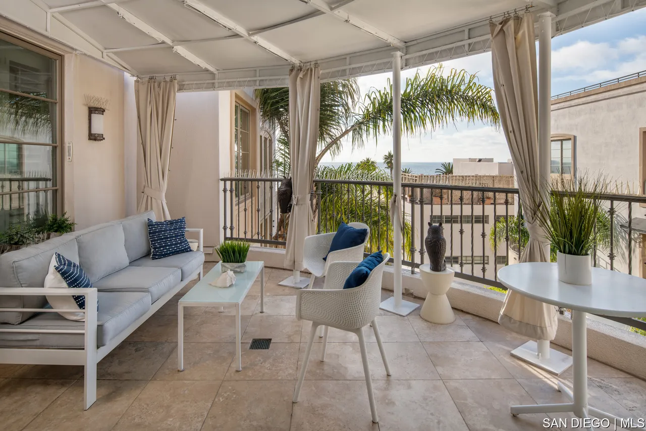 464 Prospect Street, Unit PH5 La Jolla, CA 92037 - Photo 10 of 28 a living room with furniture and a floor to ceiling window