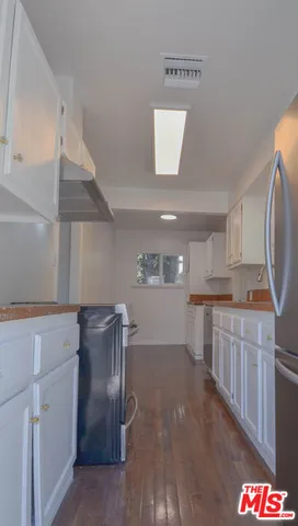 a view of a kitchen with an empty space and a window
