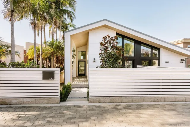 a view of a house with a potted plant and a large window