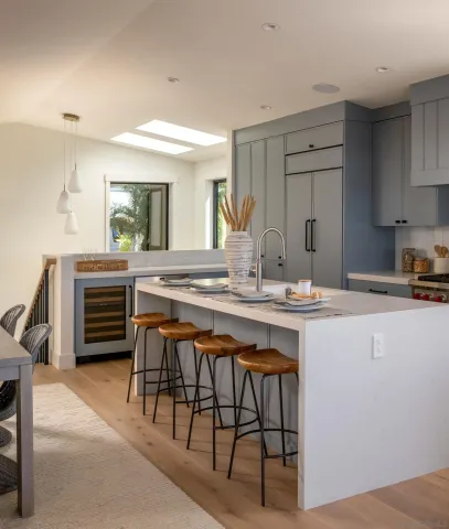 a kitchen with a table chairs sink and cabinets