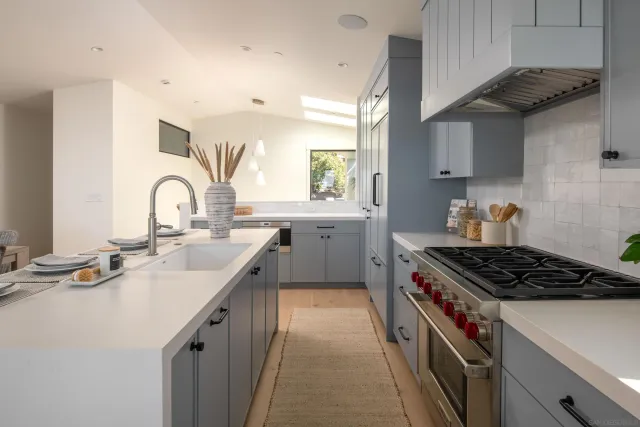 a kitchen that has a sink and a stove