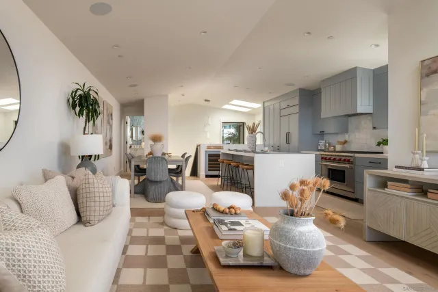 a living room with furniture stove and kitchen view