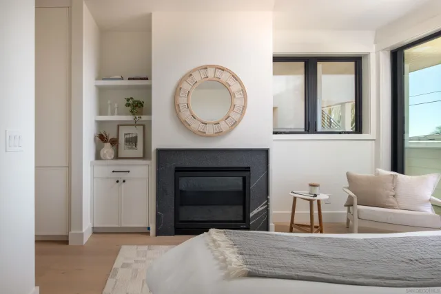 a bedroom with a bed and a fireplace