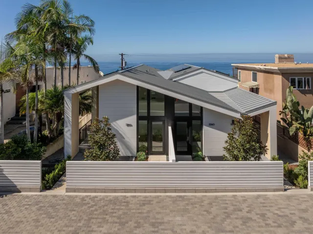 a front view of a house with a garden
