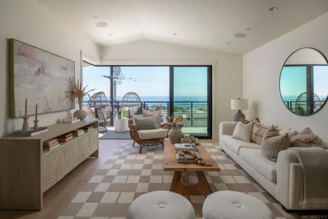 a living room with fireplace furniture and a large window