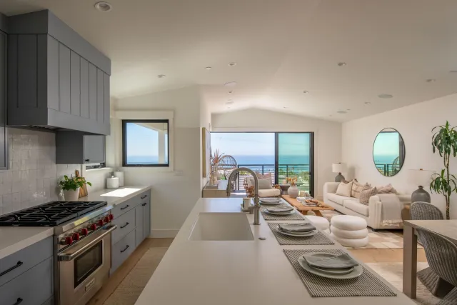 a kitchen with sink refrigerator and cabinets