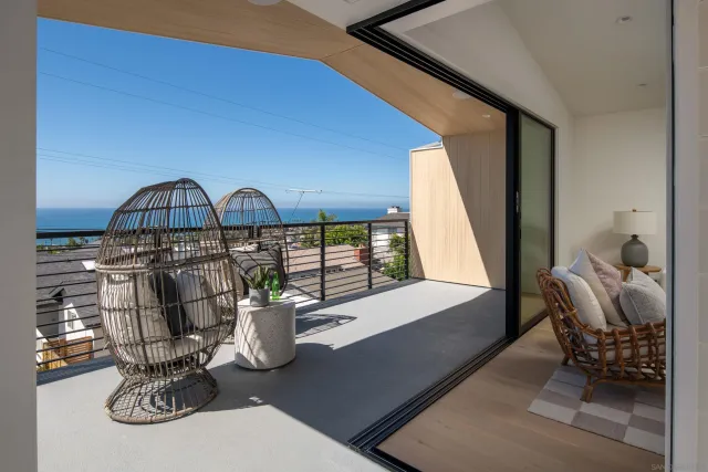a view of table and chair with potted plants