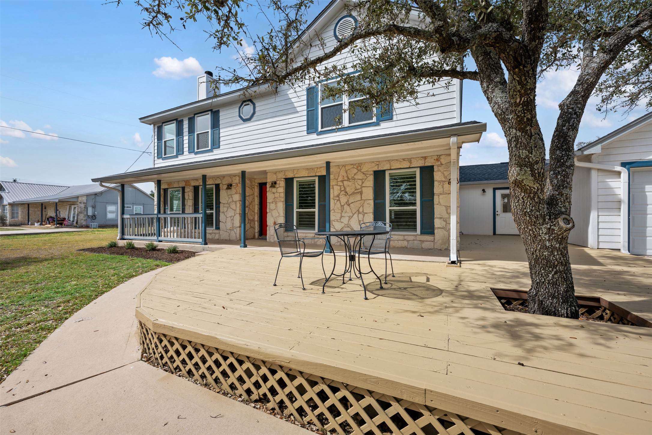 104 Sunset Road Georgetown, TX 78633 - Photo 3 of 40 Traditional-style home with stone siding, a chimney, a porch, and a garage