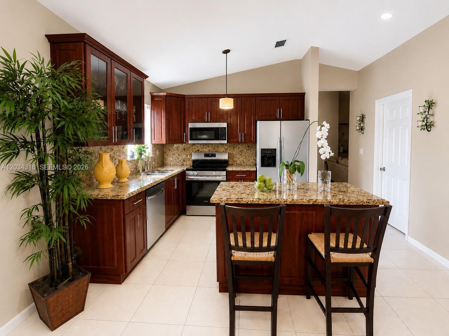 14856 Southwest 179th Street Miami, FL 33187 - Photo 11 of 33 a kitchen with stainless steel appliances granite countertop a stove a sink and a refrigerator