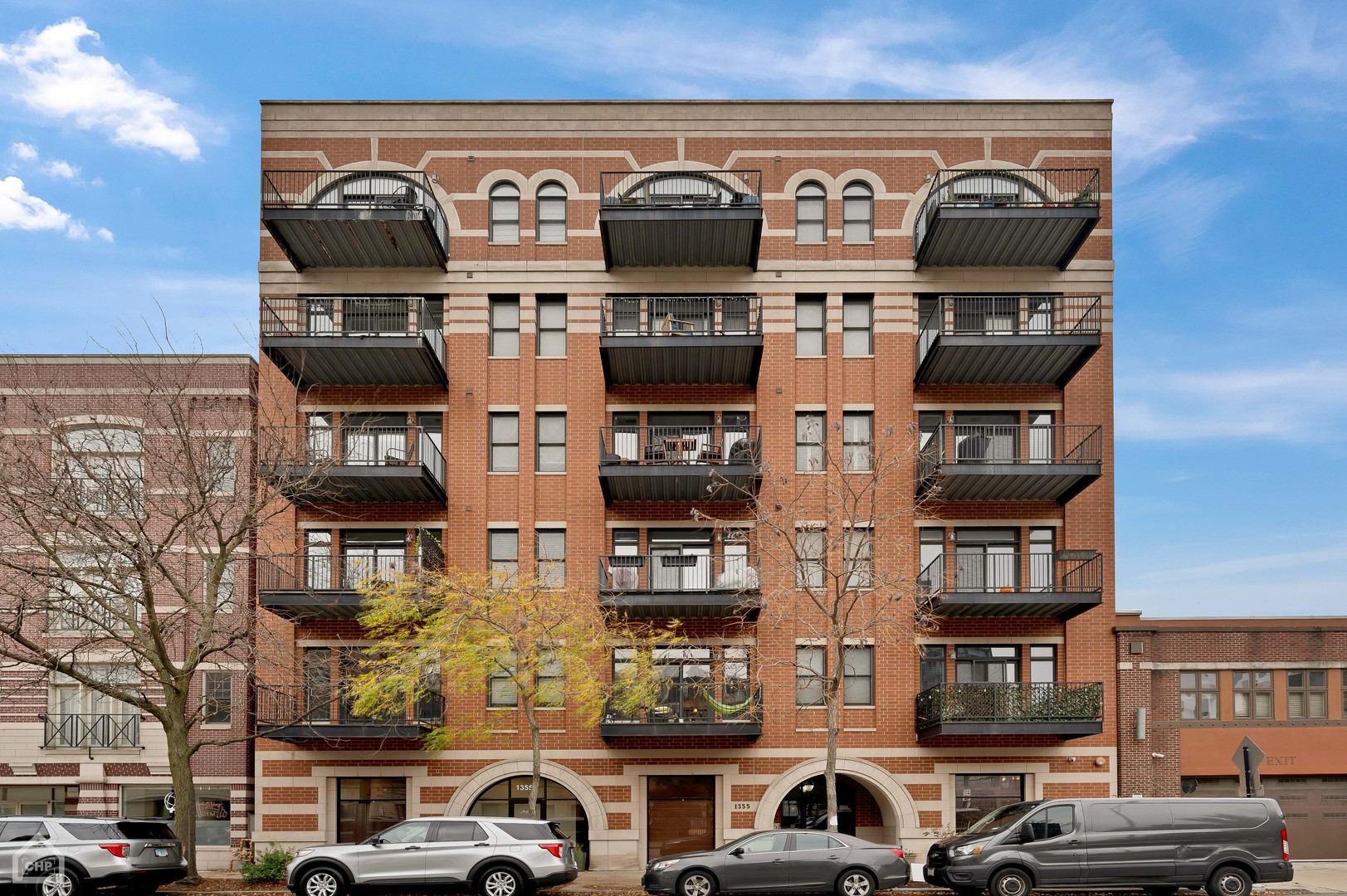 1355 West Washington Boulevard, Unit 5D Chicago, IL 60607 - Photo 1 of 1 a front view of a building with parking