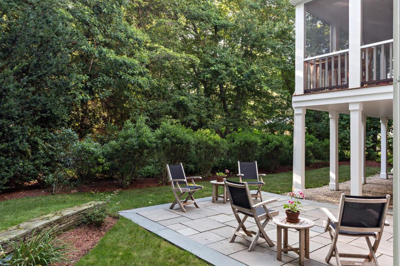 5 Uncatena Road Mashpee, MA 02649 - Photo 12 of 29 a view of a chair and table in backyard of the house