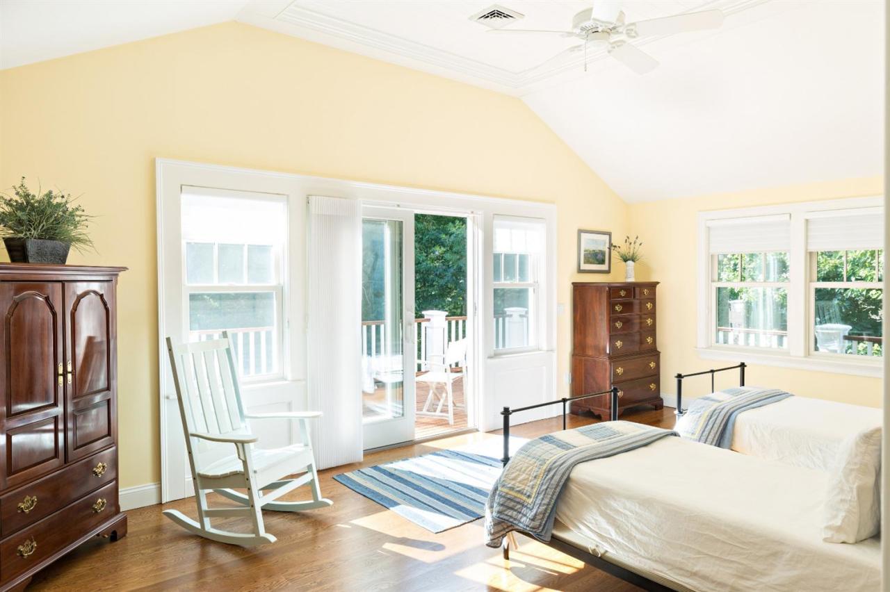 5 Uncatena Road Mashpee, MA 02649 - Photo 16 of 29 a spacious bedroom with a bed and glass door