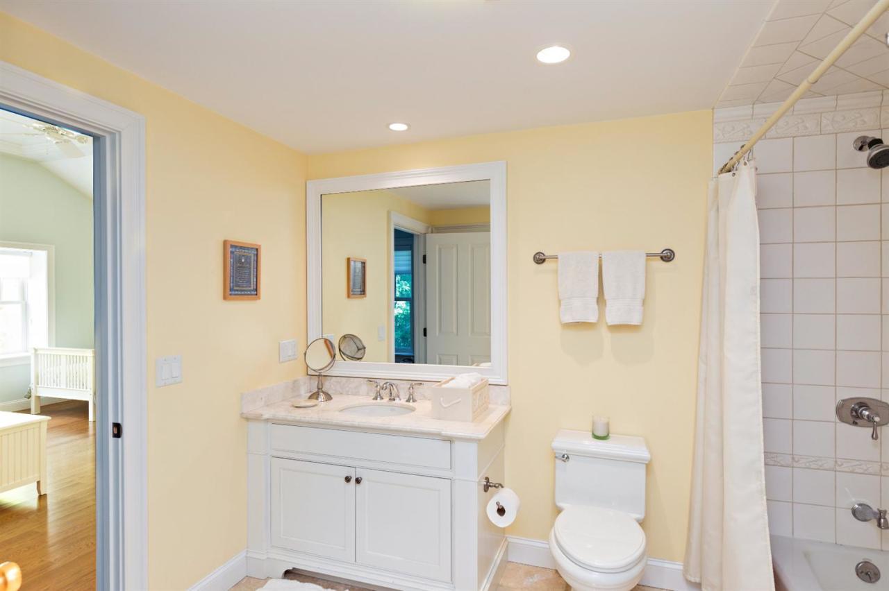 5 Uncatena Road Mashpee, MA 02649 - Photo 25 of 29 a bathroom with a toilet a sink a mirror and a shower