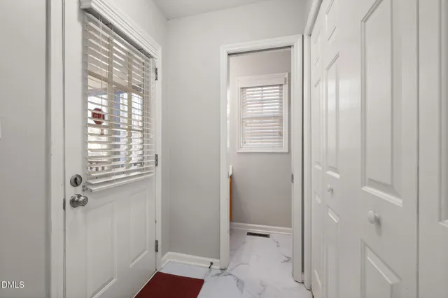 a view of a hallway with wooden floor and staircase