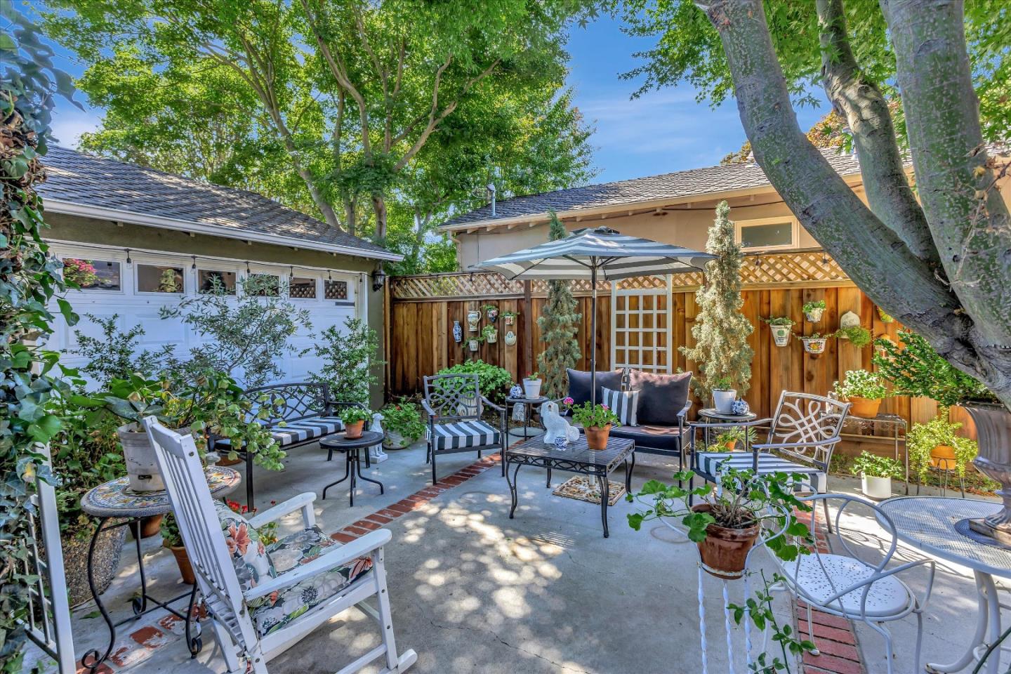 2084 Ellen Avenue San Jose, CA 95125 - Photo 40 of 43 a view of a patio with table and chairs potted plants and large tree