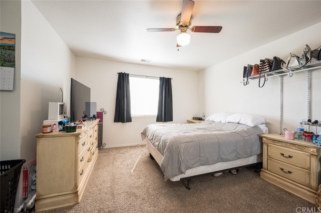 41 Brewer Street Templeton, CA 93465 - Photo 11 of 57 a bedroom with a bed and a chandelier