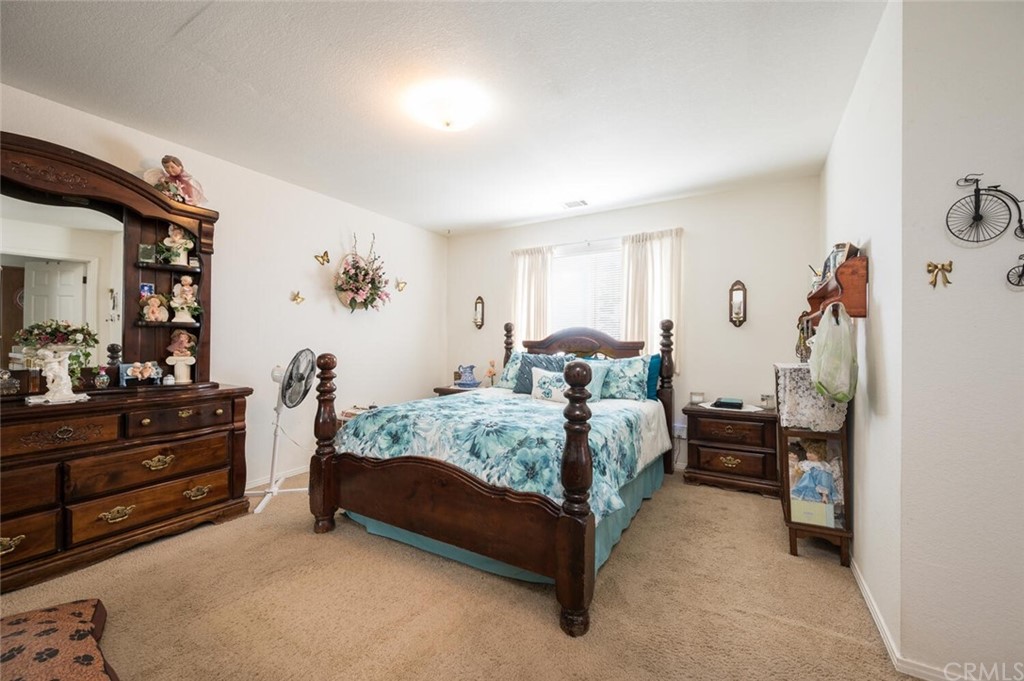 41 Brewer Street Templeton, CA 93465 - Photo 32 of 57 a bedroom with a bed and a mirror on dresser