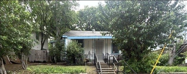 1702 Perez Street Austin, TX 78721 - Photo 4 of 17 a view of a house with brick walls and a tree