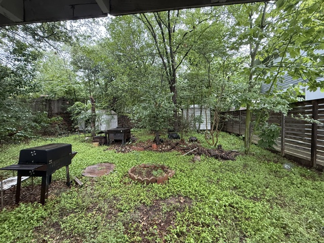 1702 Perez Street Austin, TX 78721 - Photo 7 of 17 a garden with a bench and some plants