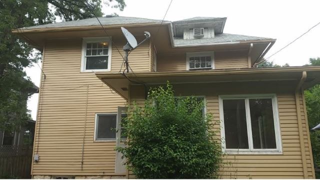 922 North Spring Street Elgin, IL 60120 - Photo 2 of 11 a front view of a house with a balcony
