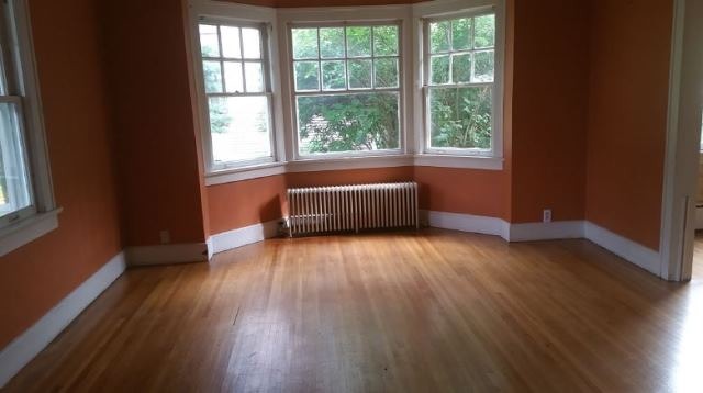 922 North Spring Street Elgin, IL 60120 - Photo 6 of 11 an empty room with wooden floor and windows