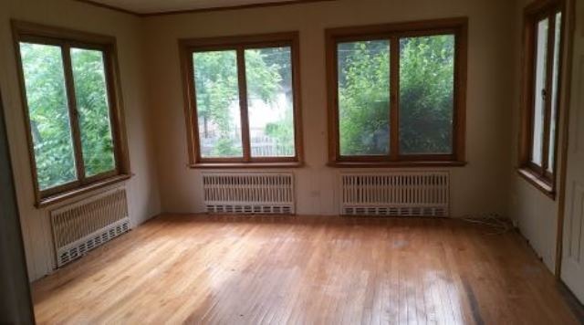 922 North Spring Street Elgin, IL 60120 - Photo 8 of 11 a view of an empty room with wooden floor and a window