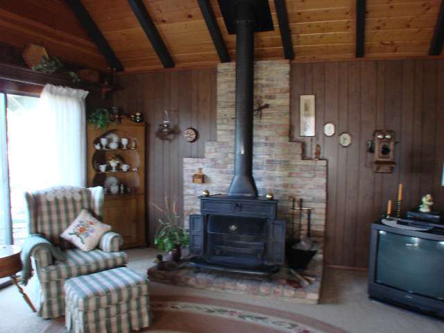 3041 Aspen Road Overgaard, AZ 85933 - Photo 2 of 5 a living room with furniture and a fireplace