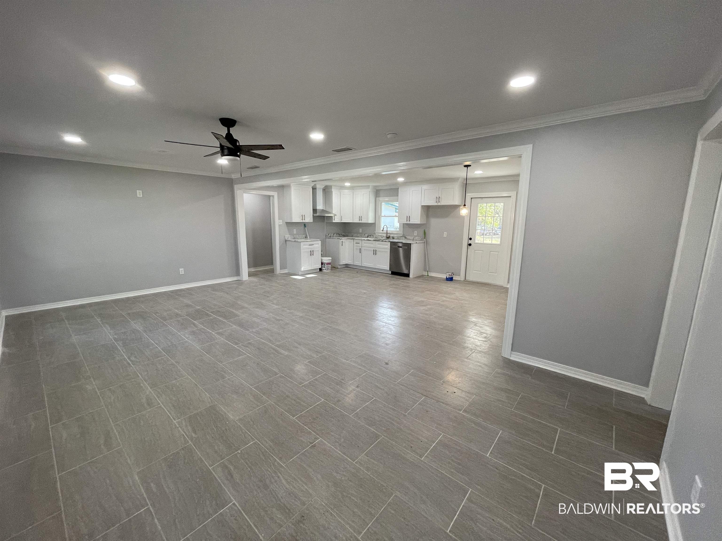 3901 Prima Vera Lane Mobile, AL 36605 - Photo 2 of 15 Unfurnished living room with crown molding and ceiling fan