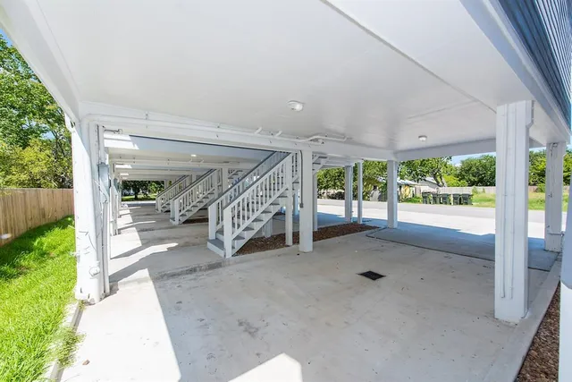 a view of a porch with a table and chairs