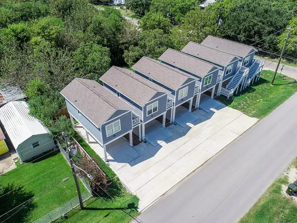 an aerial view of a house with a backyard patio and garden