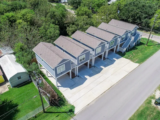 an aerial view of a house with a backyard patio and garden