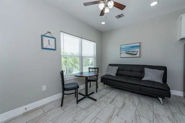 a view of a livingroom with furniture and a window
